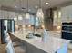 Spacious kitchen boasts white cabinets, stainless steel appliances, and a large center island at 3397 Sagebrush St, Harmony, FL 34773