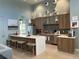 Open kitchen with stainless steel appliances, granite countertops, and an eat-in island with barstool seating at 3397 Sagebrush St, Harmony, FL 34773