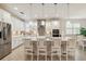 A modern white kitchen features stainless steel appliances and an island at 3397 Sagebrush St, Harmony, FL 34773
