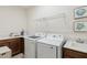 Functional laundry room with a washer, dryer, sink, and ample counter space at 3397 Sagebrush St, Harmony, FL 34773