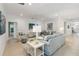 Bright living room featuring stylish sofas, elegant decor, and an open layout for seamless entertaining at 3397 Sagebrush St, Harmony, FL 34773