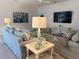 Comfortable living room featuring soft blue sofa, throw pillows, and beachy decor at 3397 Sagebrush St, Harmony, FL 34773