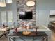 Inviting living room features a stone accent wall with mounted television and comfortable seating arrangements at 3397 Sagebrush St, Harmony, FL 34773