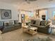 Bright living room flowing into kitchen featuring neutral decor, ceiling fan, and comfortable seating at 3397 Sagebrush St, Harmony, FL 34773