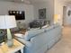 Comfortable living room with blue sofa, side tables, TV and coastal decor at 3397 Sagebrush St, Harmony, FL 34773