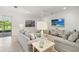Cozy living room featuring a comfortable seating arrangement, a flat-screen TV, and access to the outdoor patio at 3397 Sagebrush St, Harmony, FL 34773