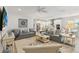 Bright living room with neutral decor, comfortable seating, and an open floor plan at 3397 Sagebrush St, Harmony, FL 34773