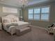 Relaxing bedroom features soft green walls, plantation shutters, and a crystal chandelier at 3397 Sagebrush St, Harmony, FL 34773