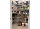 Walk-in pantry with plenty of storage and shelving, including woven baskets and a variety of food items at 3397 Sagebrush St, Harmony, FL 34773