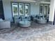 Outdoor patio featuring grey wicker furniture, round tables, and a modern design at 3397 Sagebrush St, Harmony, FL 34773