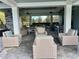 Outdoor patio featuring stone columns, ceiling fans, and comfortable lounge seating at 3397 Sagebrush St, Harmony, FL 34773