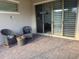 Covered patio featuring brick pavers, rocking chairs, and a sliding glass door entry at 3397 Sagebrush St, Harmony, FL 34773