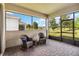 Screened-in patio with brick floors, comfortable seating, and a view of the serene backyard at 3397 Sagebrush St, Harmony, FL 34773
