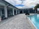 Community pool with modern clubhouse, a splash area and outdoor seating at 3397 Sagebrush St, Harmony, FL 34773