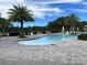 Community pool with wading area, lounge chairs, palm trees, and green space at 3397 Sagebrush St, Harmony, FL 34773