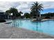 Resort-style community pool with lounge chairs, palm trees, and seating areas at 3397 Sagebrush St, Harmony, FL 34773