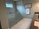 Modern bathroom with glass shower, mosaic tile, and elegant fixtures, surrounded by art at 3397 Sagebrush St, Harmony, FL 34773