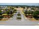 Aerial view of a gated community entrance with lush landscaping and well-maintained grounds at 344 Cadiz Loop, Davenport, FL 33837