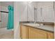 Bathroom featuring vanity with wood cabinets, a gray countertop, and a shower with a teal curtain at 344 Cadiz Loop, Davenport, FL 33837