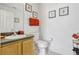 A clean bathroom with a vanity, sink, toilet, and decorative wall art at 344 Cadiz Loop, Davenport, FL 33837