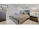 A cozy bedroom featuring a queen bed, carpeted floors, and bedside tables at 344 Cadiz Loop, Davenport, FL 33837