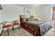 A comfortable bedroom featuring a queen bed with two side chairs and carpeted floors at 344 Cadiz Loop, Davenport, FL 33837
