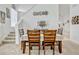 Dining area with wood chairs, a dining table, and carpeted floors with decorative wall accents at 344 Cadiz Loop, Davenport, FL 33837