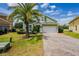 Charming two-story home with green siding, brick driveway, and a well-maintained front yard at 344 Cadiz Loop, Davenport, FL 33837