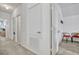 A carpeted hallway featuring multiple doorways, a utility closet, and light walls at 344 Cadiz Loop, Davenport, FL 33837