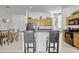 Bright kitchen features tile floors, breakfast bar, and oak cabinetry at 344 Cadiz Loop, Davenport, FL 33837