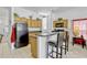 Bright kitchen features tile floors, breakfast bar, and oak cabinetry at 344 Cadiz Loop, Davenport, FL 33837
