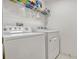 Laundry room featuring white appliances and tile flooring at 344 Cadiz Loop, Davenport, FL 33837