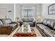 Comfortable living room offers ample seating and a large window for natural light at 344 Cadiz Loop, Davenport, FL 33837
