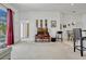 Open-concept living area with modern decor, neutral carpet, bar stool seating, and access to the screened pool at 344 Cadiz Loop, Davenport, FL 33837