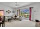 Bright living room with gray leather sofas, neutral carpet, and sliding glass doors to a screened pool at 344 Cadiz Loop, Davenport, FL 33837