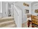 Carpeted staircase leading to the upper level, with dining area, and living room at 344 Cadiz Loop, Davenport, FL 33837