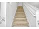 Carpeted stairs lead to the second floor with white trim and a landing door at the top at 344 Cadiz Loop, Davenport, FL 33837
