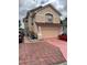 Two-story house with a large garage and a brick driveway at 3772 Huntwicke Blvd, Davenport, FL 33837