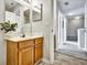 Cozy, well-lit bathroom featuring a wooden vanity, mirror, and modern wood-style flooring at 4560 Spigold Court, Kissimmee, FL 34746