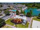 Aerial view of the community playground and pool, next to a lake and surrounded by manicured landscaping at 4560 Spigold Court, Kissimmee, FL 34746