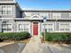 Inviting townhome with a vibrant red door and convenient handicap parking access at 4560 Spigold Court, Kissimmee, FL 34746