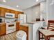 Well-lit kitchen with white appliances and cozy breakfast bar seating for two at 4560 Spigold Court, Kissimmee, FL 34746