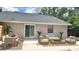 Charming backyard patio with outdoor seating, perfect for relaxing and enjoying the outdoors with mature trees at 5284 Indian Laurel Ct, Orlando, FL 32808
