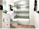 Updated bathroom featuring modern fixtures, vanity, and a shower/tub combination with tiled walls at 5284 Indian Laurel Ct, Orlando, FL 32808