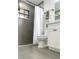 Modern bathroom with gray tile, black hardware, white vanity and shower curtain, creating a stylish, contemporary look at 5284 Indian Laurel Ct, Orlando, FL 32808