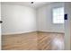 Bright bedroom featuring wood-look flooring, neutral walls and a window with blinds at 5284 Indian Laurel Ct, Orlando, FL 32808