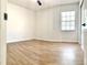 Empty bedroom with wood-look floors, neutral walls, a ceiling fan, and a window for natural light at 5284 Indian Laurel Ct, Orlando, FL 32808