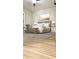 Tastefully staged bedroom with wood-look floors, neutral walls, and a stylish furniture arrangement at 5284 Indian Laurel Ct, Orlando, FL 32808