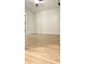 Empty bedroom with wood-look floors, neutral walls, ample space, and a door to the rest of the home at 5284 Indian Laurel Ct, Orlando, FL 32808