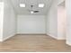 Bright, spacious room with wood-look floors, recessed lighting, and ample space for customization at 5284 Indian Laurel Ct, Orlando, FL 32808